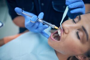 dentist doing injection in person's gum