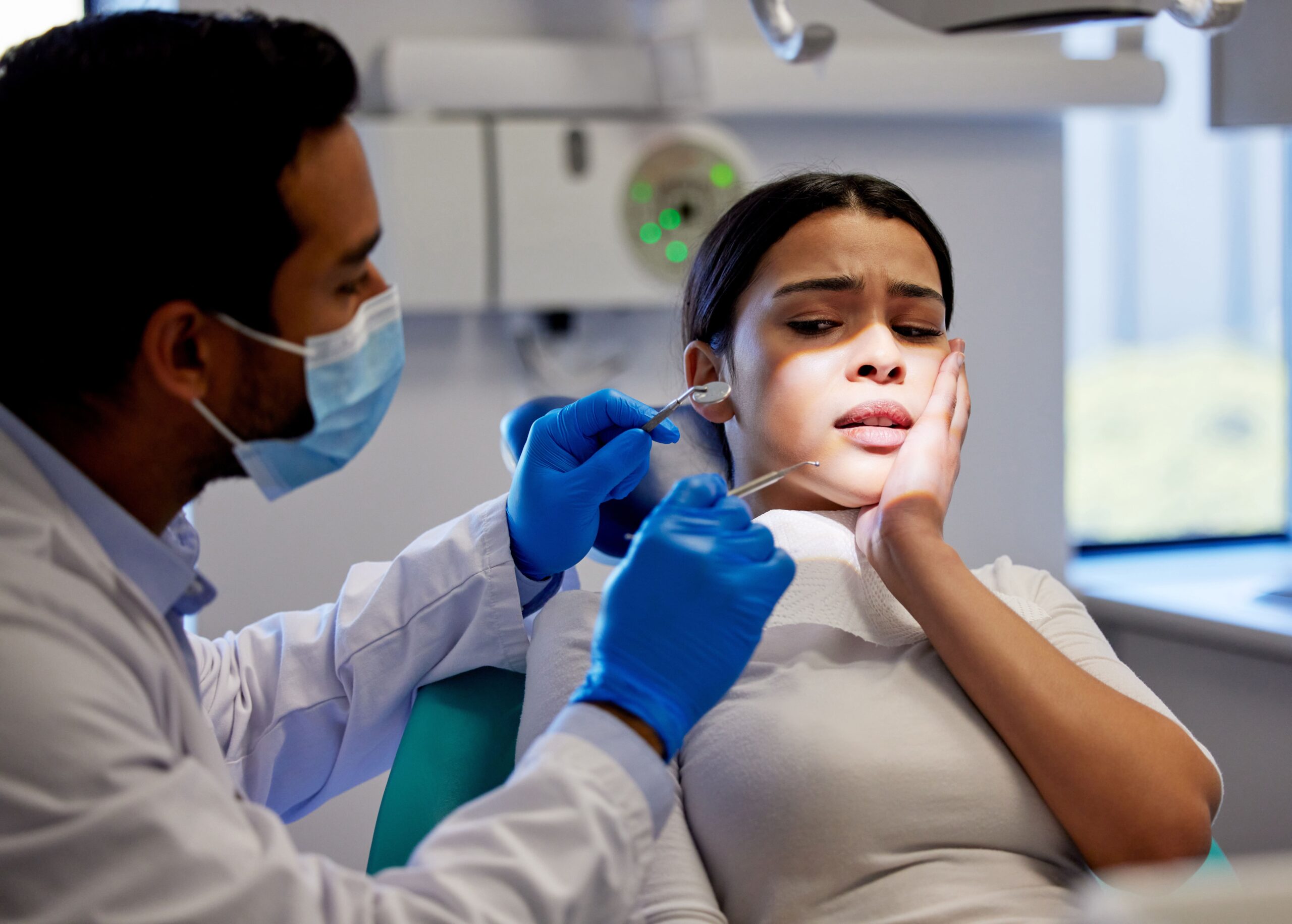 person scared of dental tool & having tooth pain