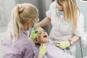 dentist and assistant working on child patient