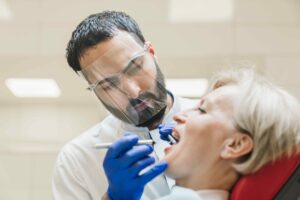 doctor performing an oral health checkup on a patient